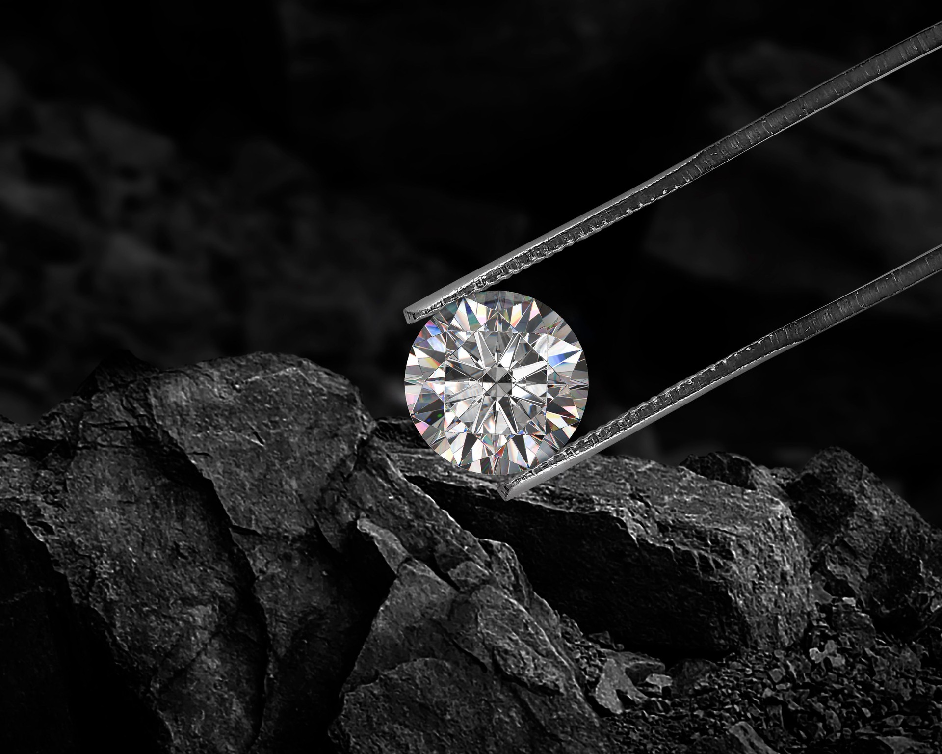 Cut Beautiful diamond held by tweezers on black coal background